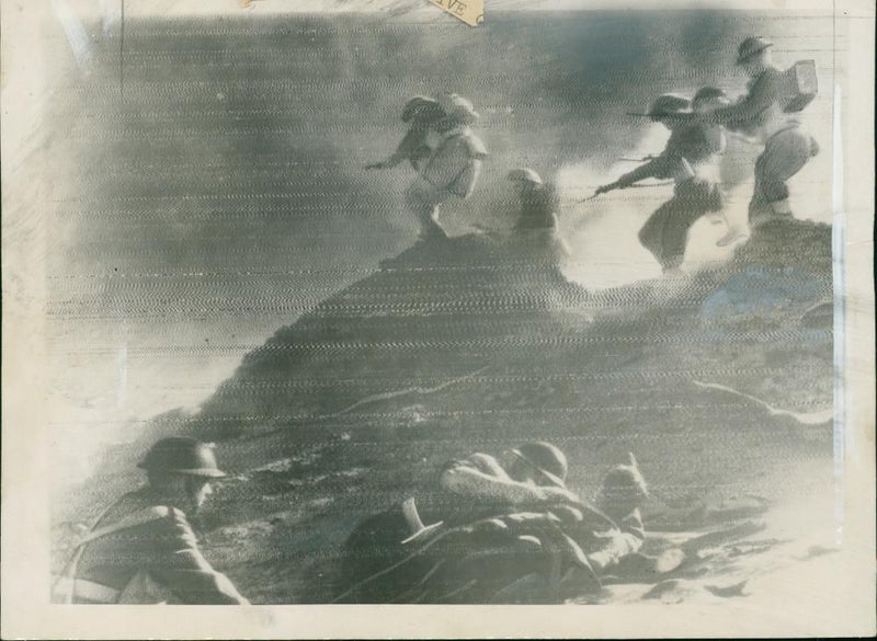 Inlantry of the eighth army rout enemy rearguards from their strong defensive position in a wadi outside sirte. - Vintage Photograph