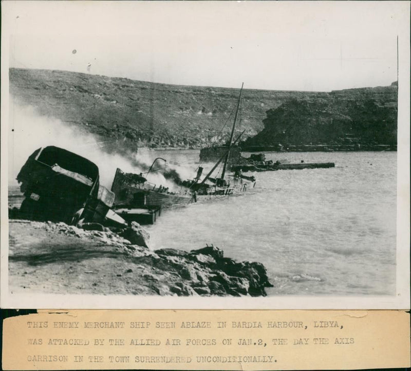 Enemy Merchant Ship seen ablaze in bardia harbour libya. - Vintage Photograph