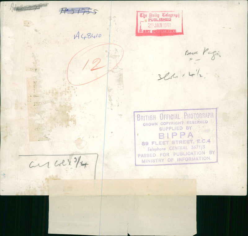 Squatting on boxes on the libyan sands are large groups. - Vintage Photograph