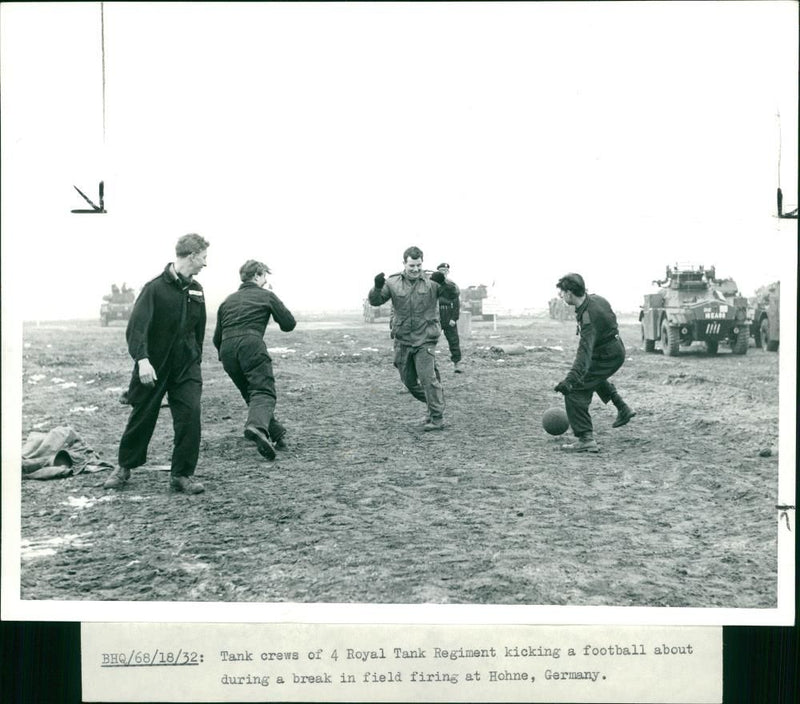 Tank crews of 4 Royal Tank Regiment kicking a football about during a break field firing at Hohne, Germany. - Vintage Photograph