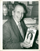 Johannes Hanau: He sits in his Soho Office with a copy of the book - Vintage Photograph