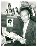 Johannes Hanau: He sits in his Soho Office with a copy of the book - Vintage Photograph