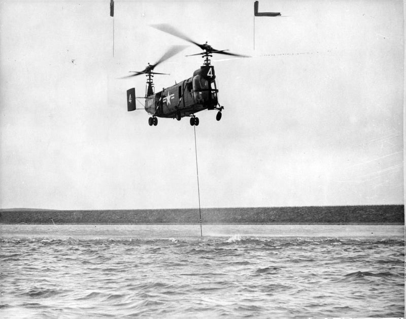 U s helicopter tests a united states navy bell helicopter with its submarine detection equipment. - Vintage Photograph