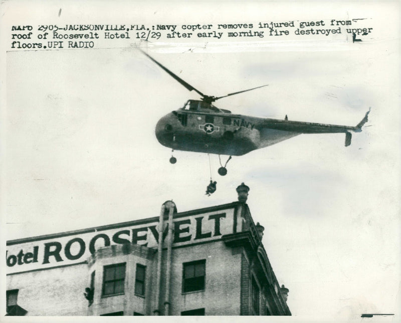 A naval helicopter rescuing an injured guest. - Vintage Photograph