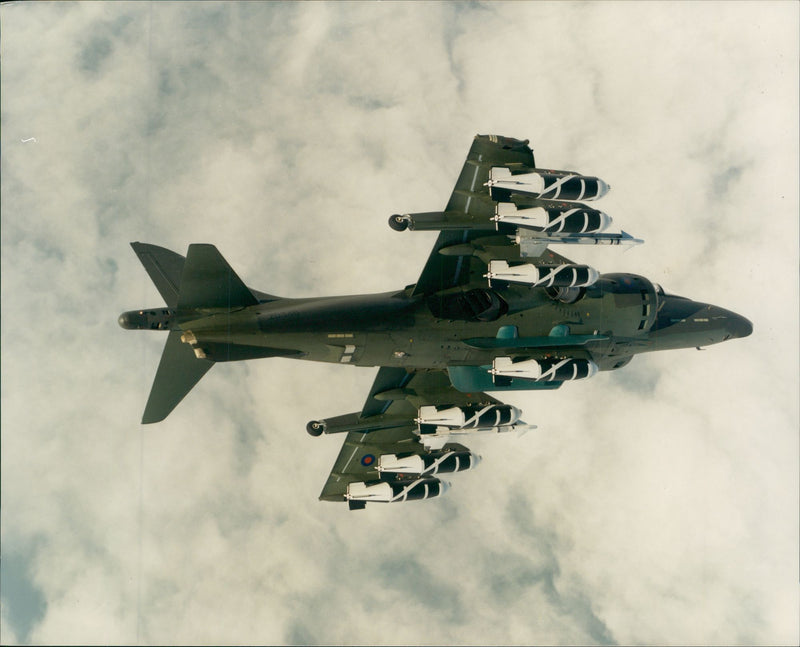 A Harrier GR5 on trials with british aerospace, showing a full weapons load. - Vintage Photograph