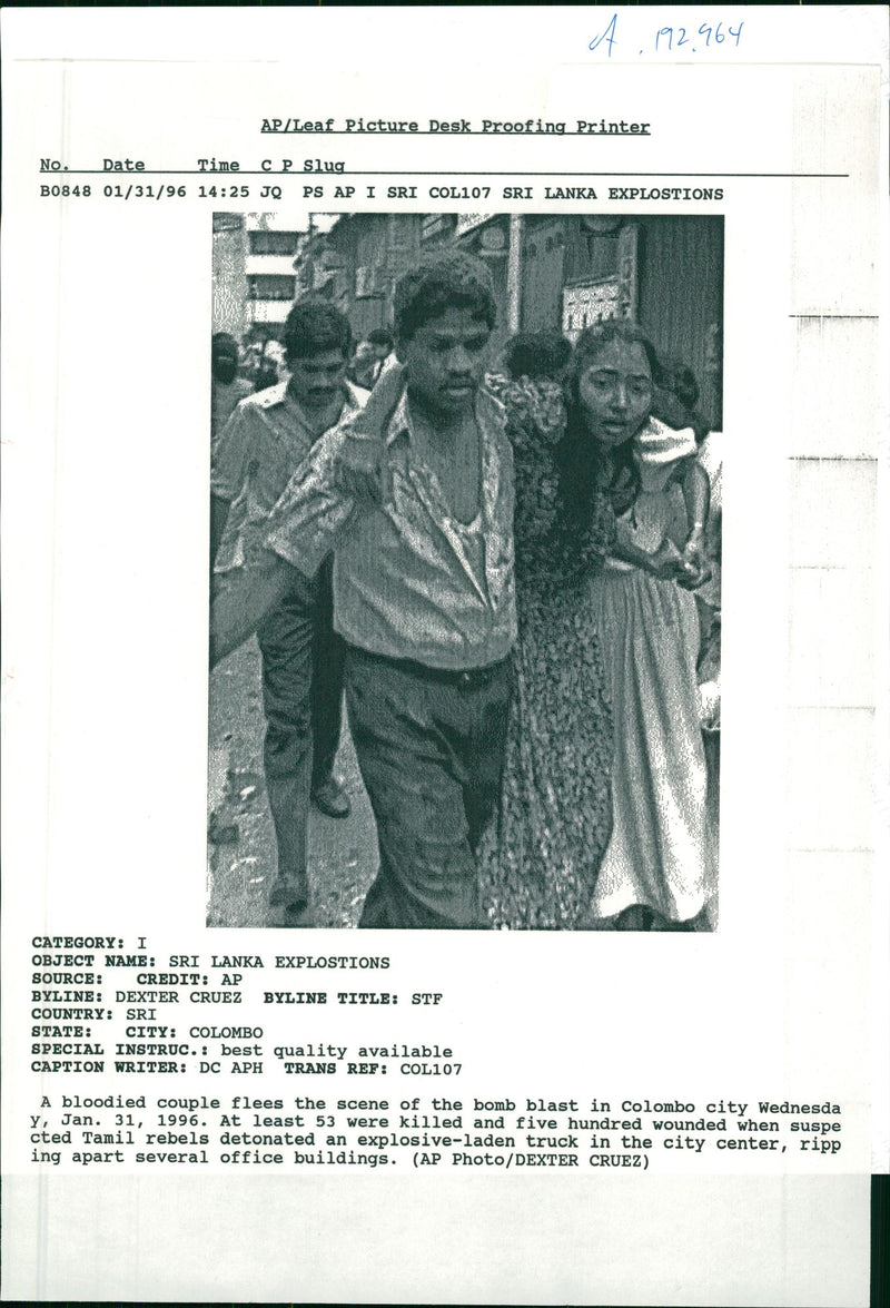 A bloodied couple flees the scene of the bomb blast in Colombo city. - Vintage Photograph