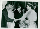 Queen Elizabeth shakes hands with Jimmi James, Vivian Blaine and Eve Boswell at the Variete show "Guys and Dolls" - Vintage Photograph