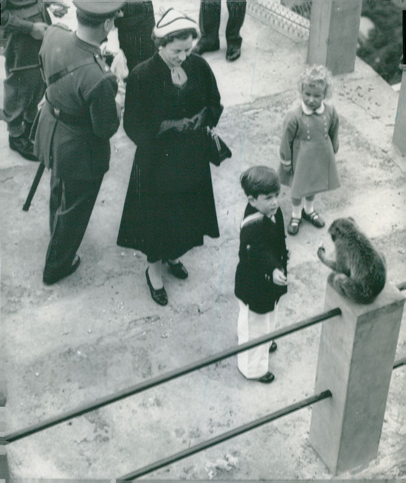 Prince Charles and Princess Anne feed one of Gibraltar's famous monkeys - Vintage Photograph