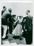 Sir John Kotelawala holds Queen Elizabeth's hand as she leaves the Parliament in Ceylon after its opening - Vintage Photograph