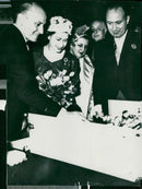 English State Visit in Paris. Queen Elizabeth admires the gift of 12 dolls handed over to Princess Anne - Vintage Photograph