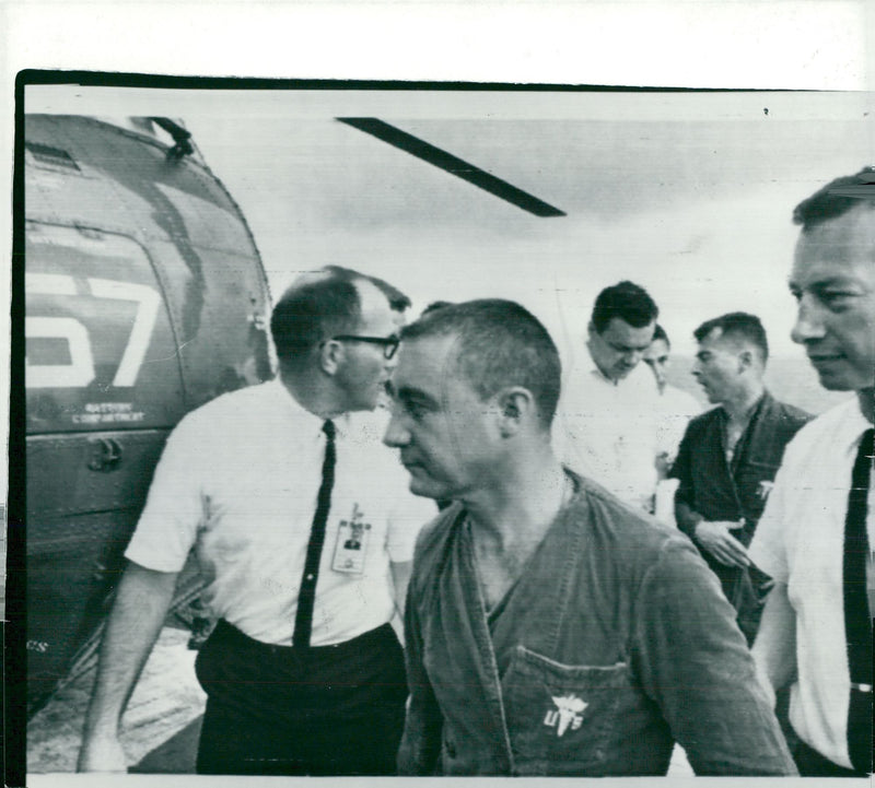 Astronauts Virgil "Gus" Grissom and John Young leave the helicopter aboard the USS Intrepid - Vintage Photograph