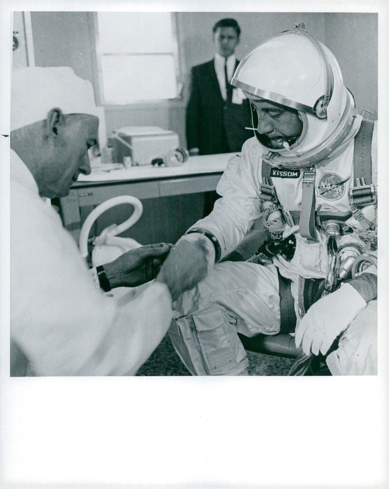 Astronaut Virgil I. Grissom gets his space suits controlled by a NASA technician - Vintage Photograph