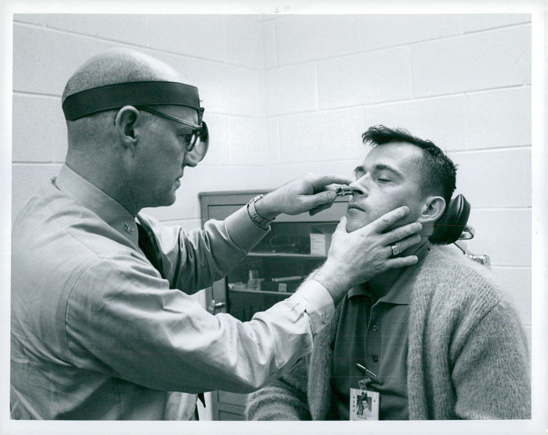 Dr. L. Ballenberger examines astronaut John W. Young - Vintage Photograph