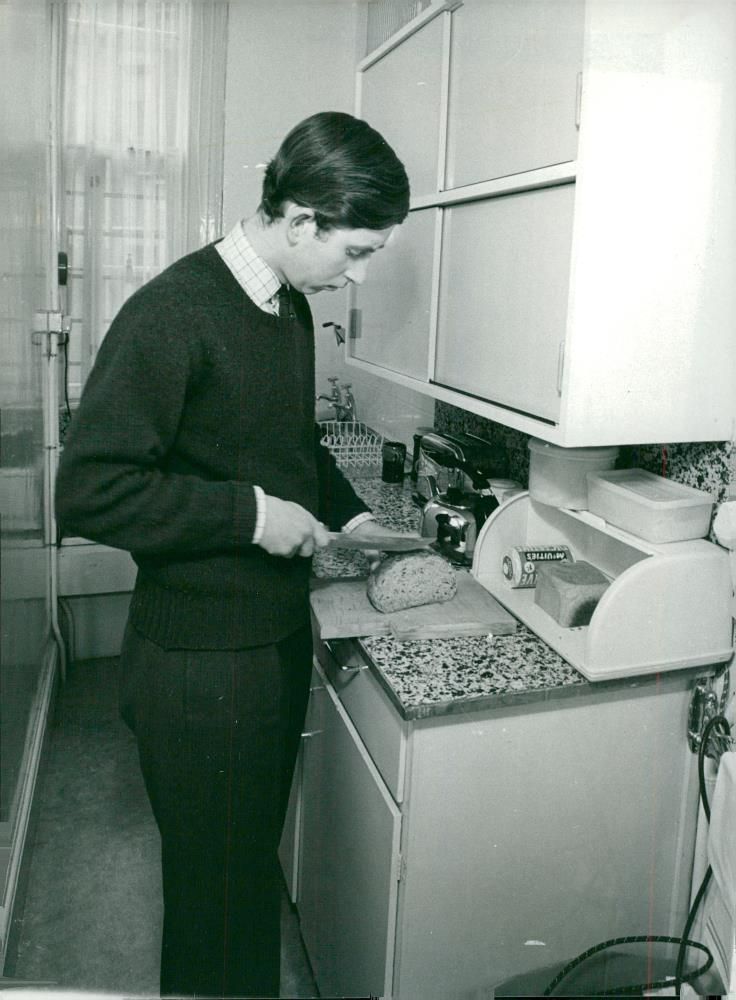 Prince Charles of Wales in the kitchen at Trinity College. - Vintage Photograph