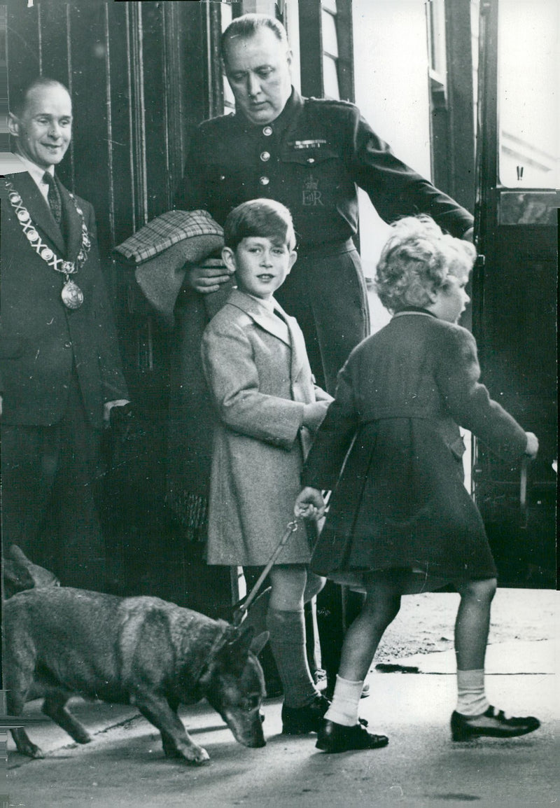 Prince Charles and Princess Anne get into a car with her dog - Vintage Photograph