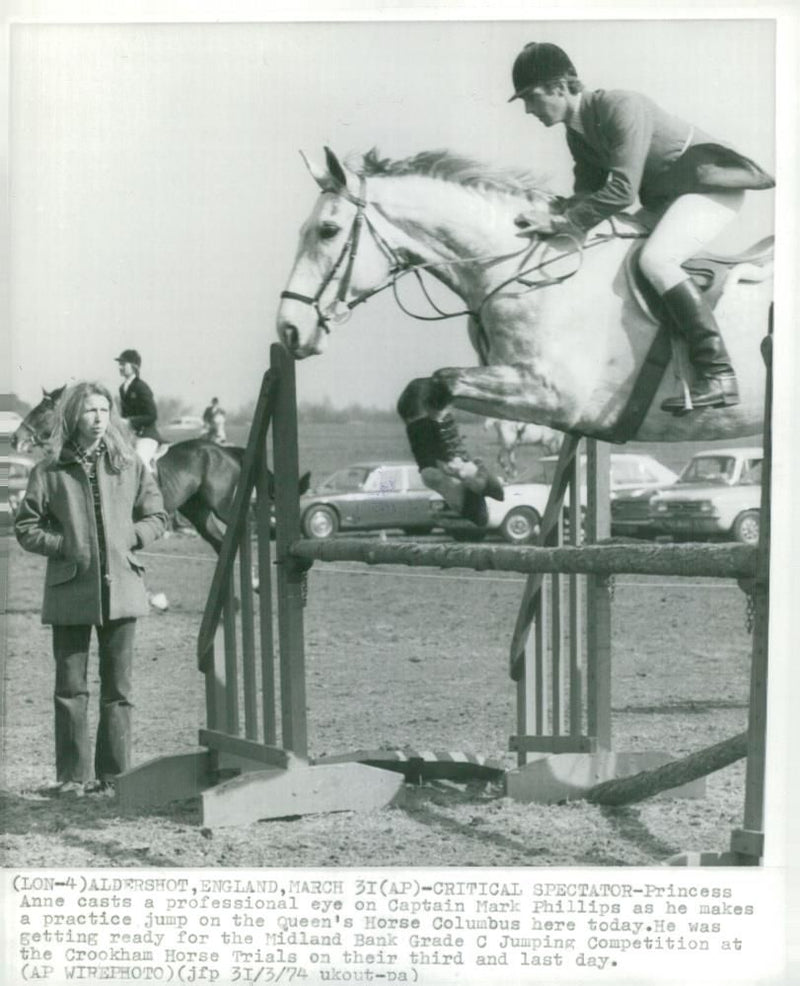 Mark Phillips jumps with the horse "Columbus" while the Princess Anne is watching - Vintage Photograph