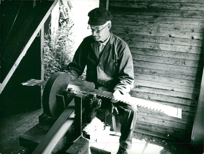 Manne Steiner grinds a saw blade in the "old saw" - Vintage Photograph