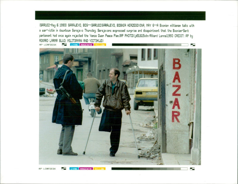 A Bosnian military talks to a war vitim. - Vintage Photograph