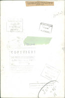 A paratrooper checking a mountain of Argentine tinnned food - Vintage Photograph