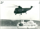 A helicopter ferrying supplies - Vintage Photograph