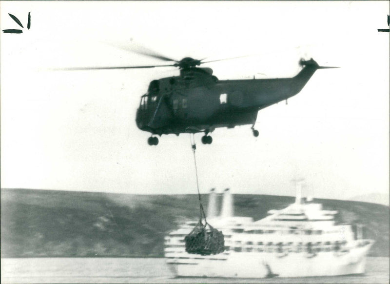 A helicopter ferrying supplies - Vintage Photograph