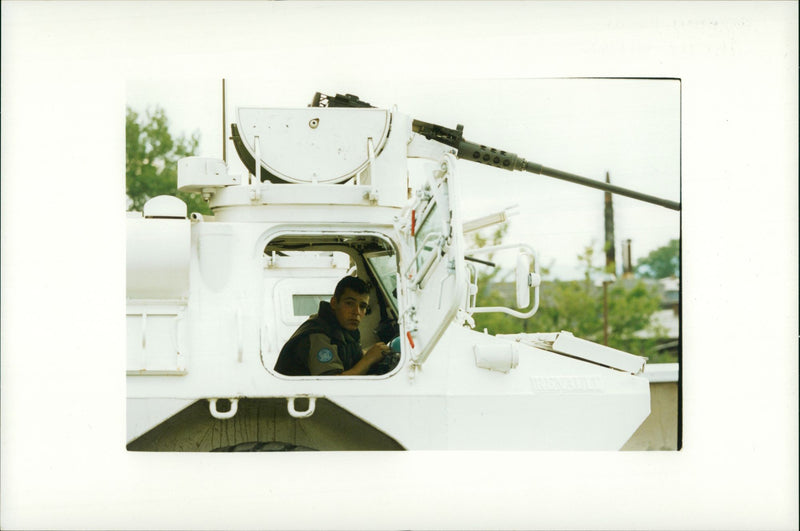 a soldier inside a vehicle. - Vintage Photograph