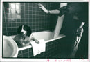 A police sniffer dog checks a hotel bathroom. - Vintage Photograph