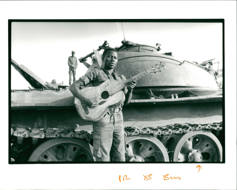 A soldier with guitar. - Vintage Photograph