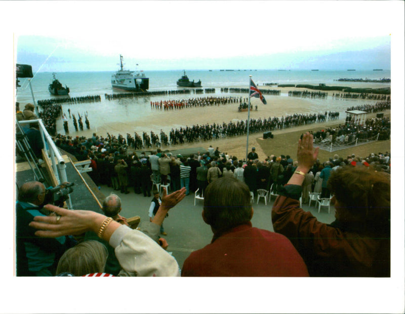 crowd waves to veterans on arromanches beach - Vintage Photograph