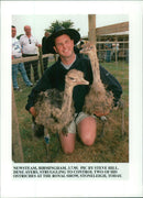 a man holding a animal - Vintage Photograph