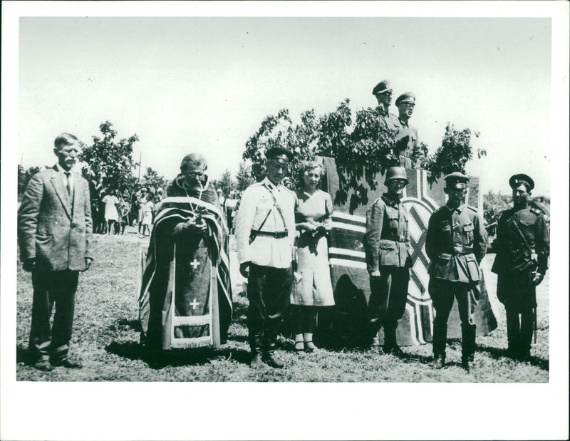 A priest with some soldiers and a woman. - Vintage Photograph