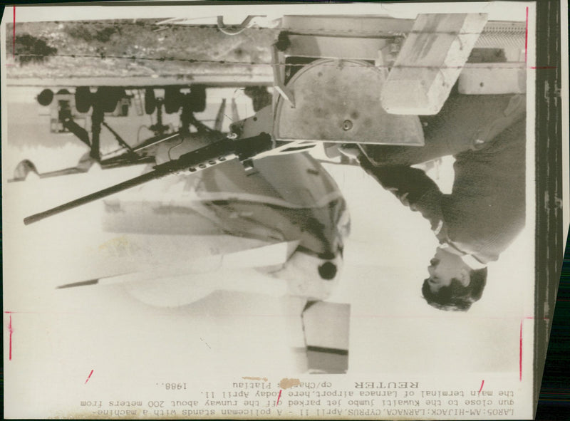 A police man sits besides his machine gun. - Vintage Photograph