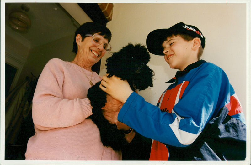 Philip Parry 10 hands pooddle Judy to her new owner. - Vintage Photograph