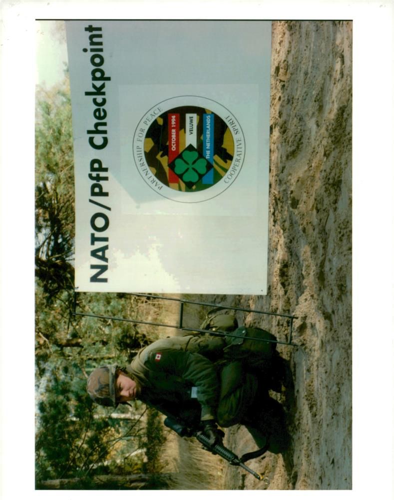 A canadian soldiers mans a checkpoint during training at the dutch military camp. - Vintage Photograph