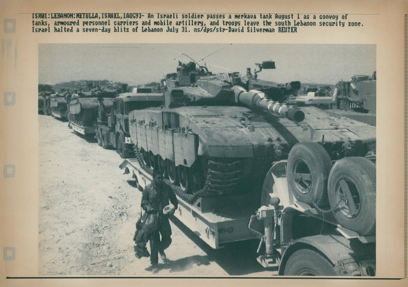 An Israeli soldier passes a merkava tank. - Vintage Photograph