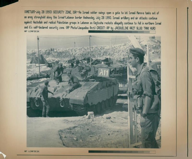 An Israeli soldier opening a gate to let the tanks in. - Vintage Photograph