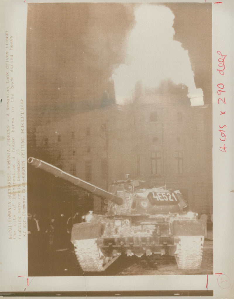 A tank is lit up by a burning Bucharest building as the army. - Vintage Photograph