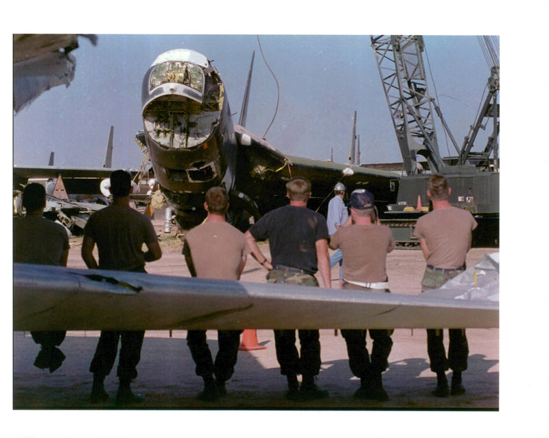 Air force personnel sitting on the aileron. - Vintage Photograph