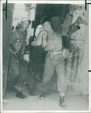 A British soldier carrying an injured Turk. - Vintage Photograph