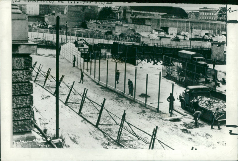 East German Soldier replacing the part of Old Berlin wall. - Vintage Photograph