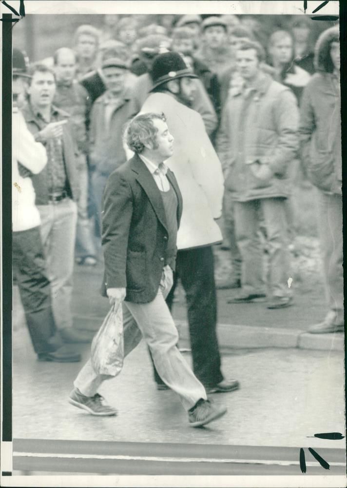 UK miners' strike 1984â85,A DerbyShire Miner Walking NonChalanty Past Pickets And Police. - Vintage Photograph