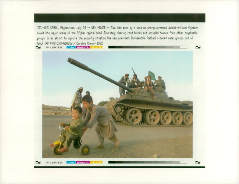 2 kids Pass By A Tank As Pro-Government Jamiat-E-Islami. - Vintage Photograph