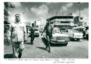 palestenian walks past an israel army - Vintage Photograph