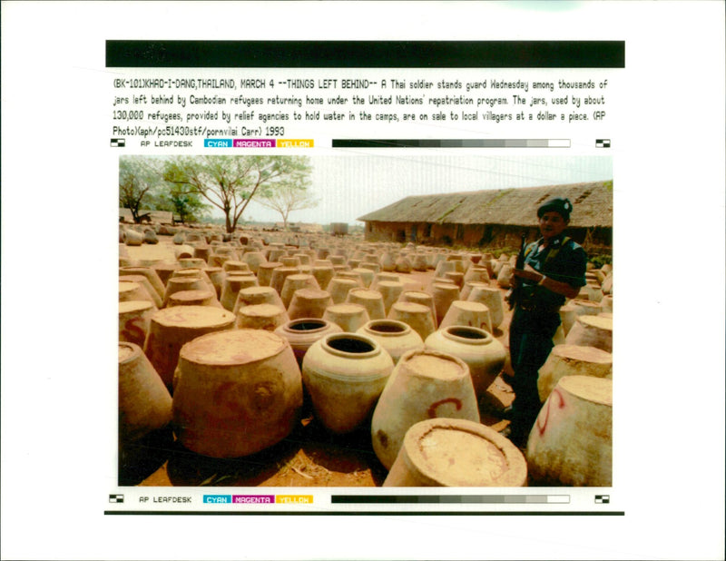 A Thai soldier stands guard among thousands of jars. - Vintage Photograph