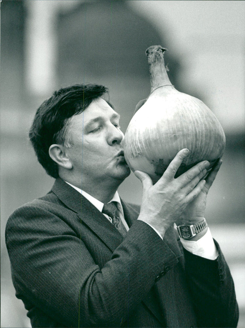 Onion grower kisses a large onion - Vintage Photograph