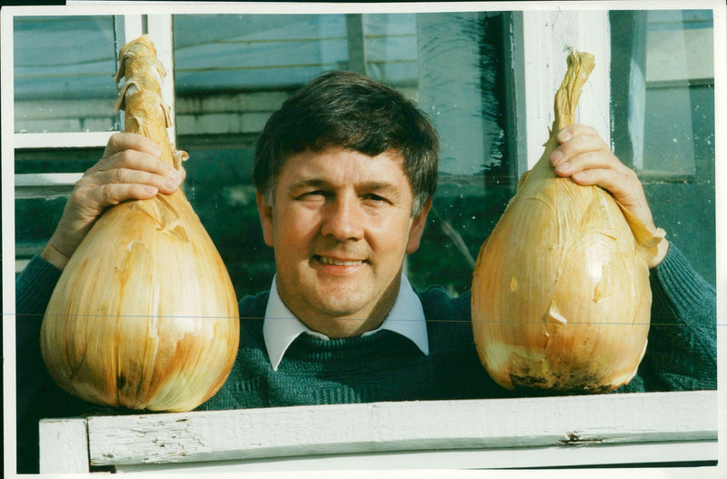 Onion grower poses with monster onion - Vintage Photograph