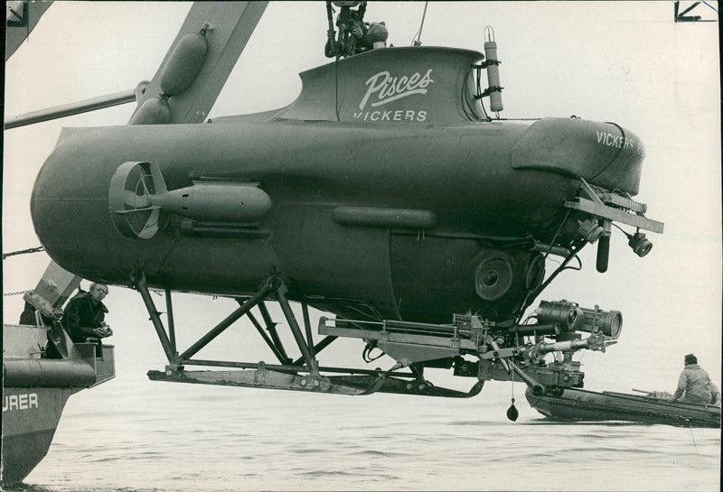 Pisces being lowered into the water. - Vintage Photograph