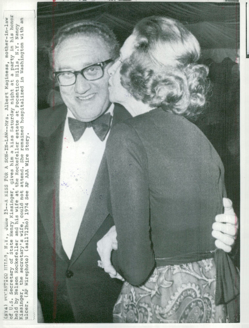 Henry Kissinger gets a kiss on the cheek by her mother-in-law, Agnes McKinley - Vintage Photograph