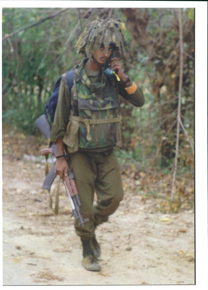 A Sri Lankan Soldier Walk's Along A Road. - Vintage Photograph