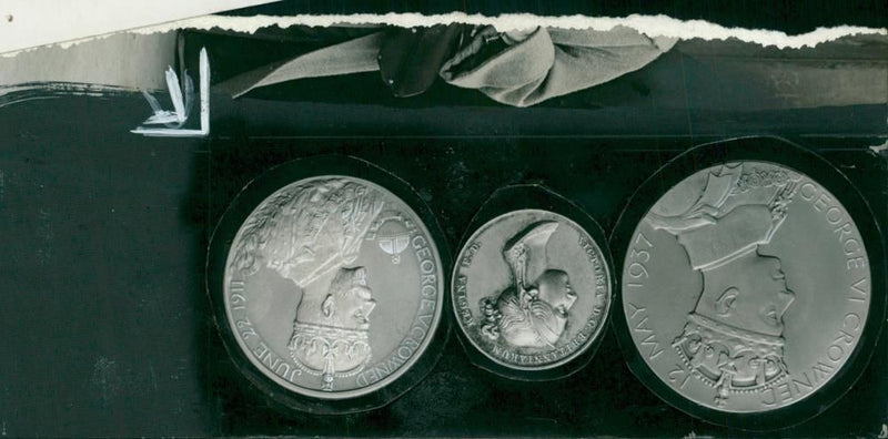 Elizabeth II and medals  commemorating the coronation of king george - Vintage Photograph